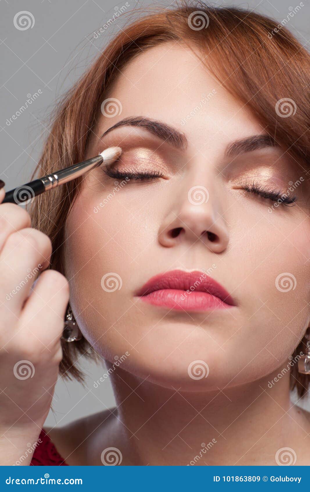 Eye makeup tutorial. Beauty model style. Eye makeup tutorial. Beauty model nude eyeshadow style. Young female with face paint on grey background. Modern pretty girl with clean skin closeup