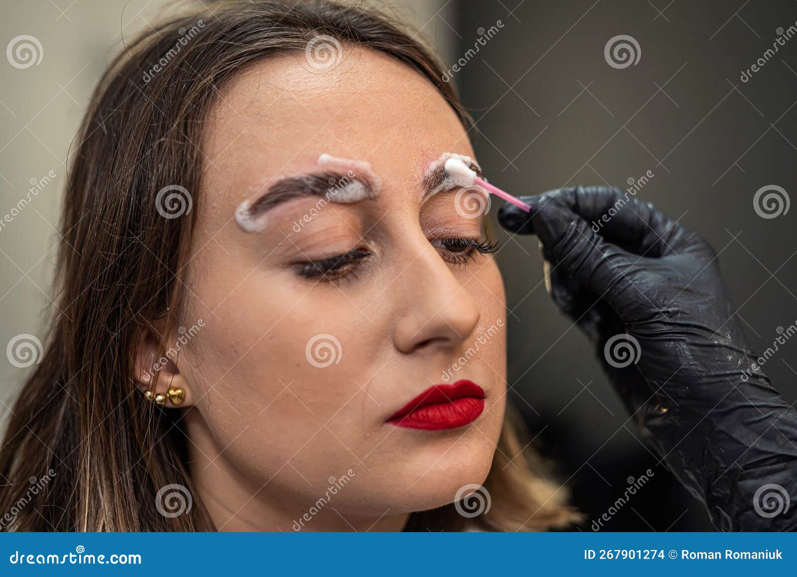 An Eyebrow Artist is Laminating the Eyebrows of a Beautiful Client. Stock Photo Image of