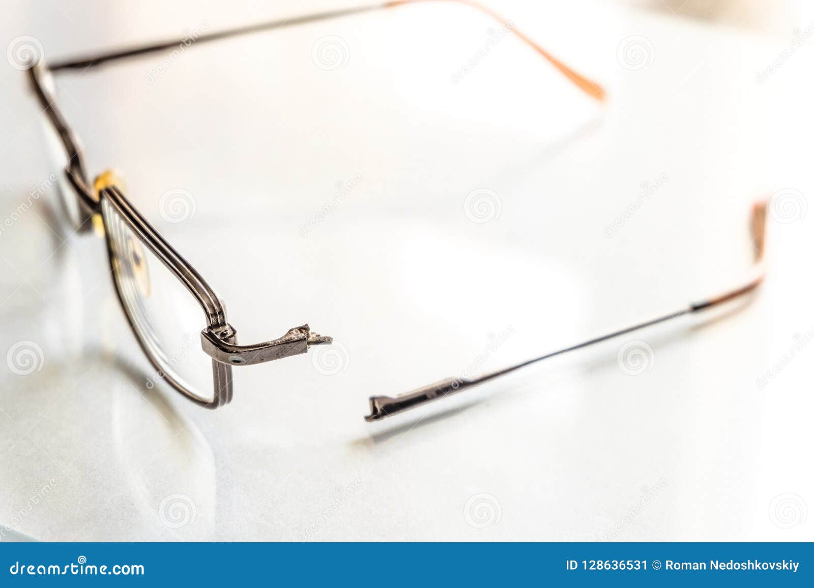 Eyeglasses With A Broken Handle On A Bright Background Stock Image