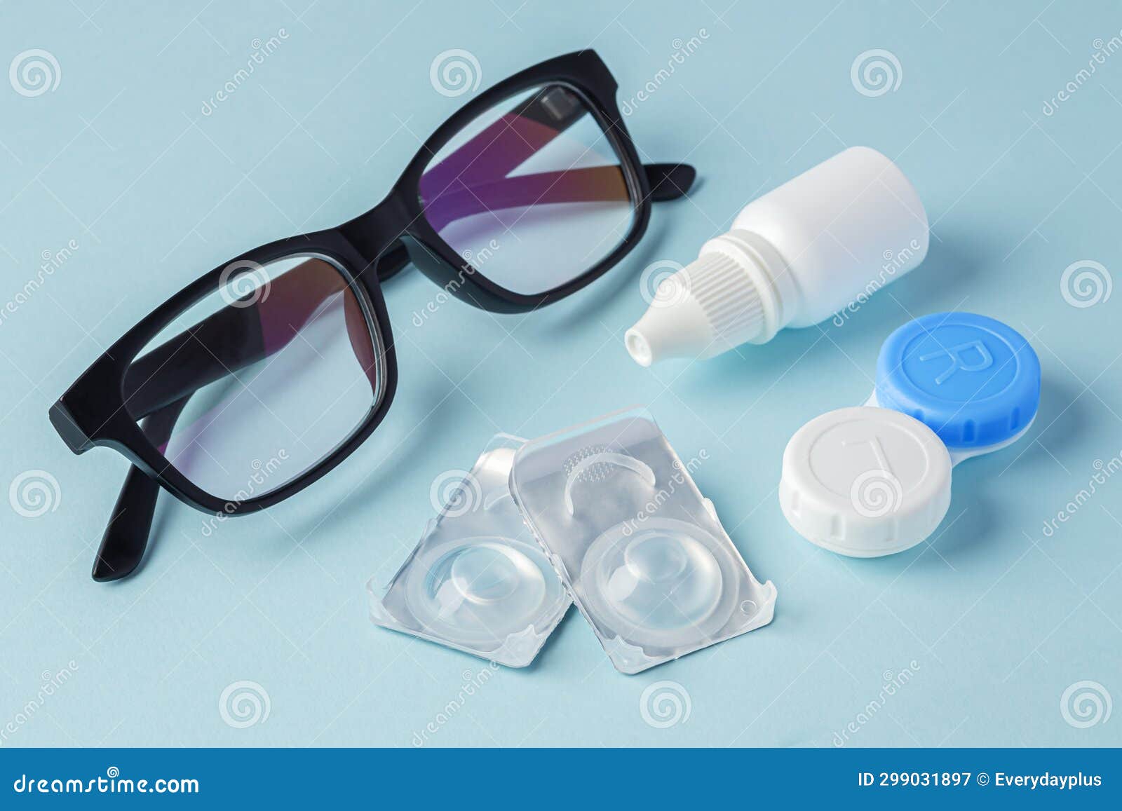 Eyeglasses and Contact Lenses with Container on Blue Background Stock
