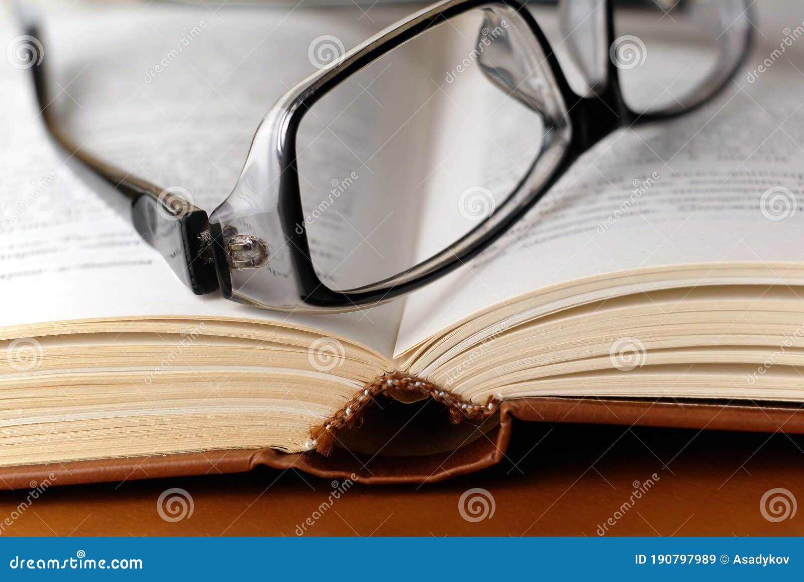 eyeglasses on open harcover book