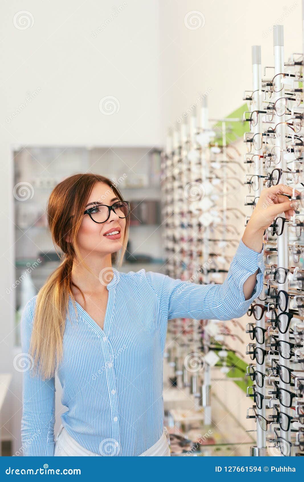 Eyeglasses Store. Woman Choosing Glasses for Eyesight Correction Stock