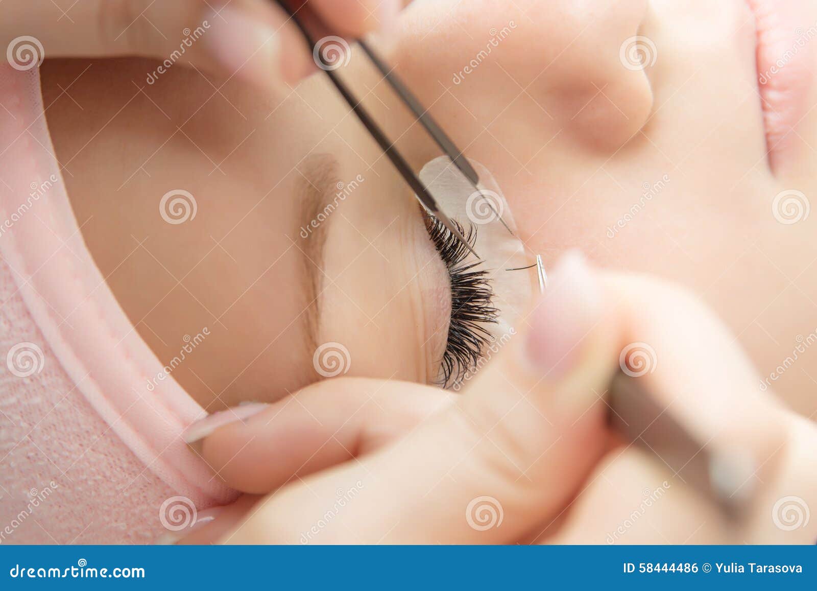eyelash extension procedure. woman eye with long eyelashes.