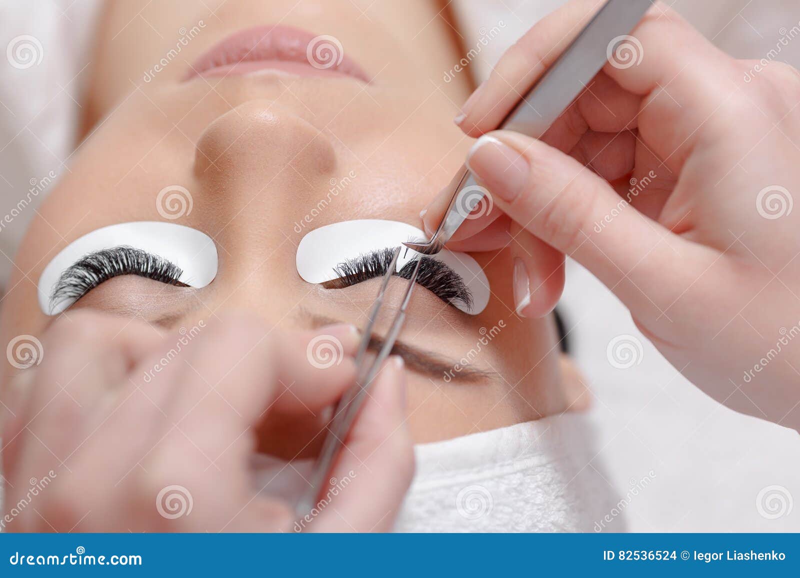 eyelash extension procedure. woman eye with long eyelashes