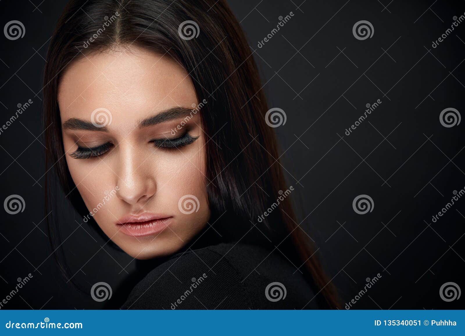 eyelashes makeup. woman beauty face with black lashes extensions