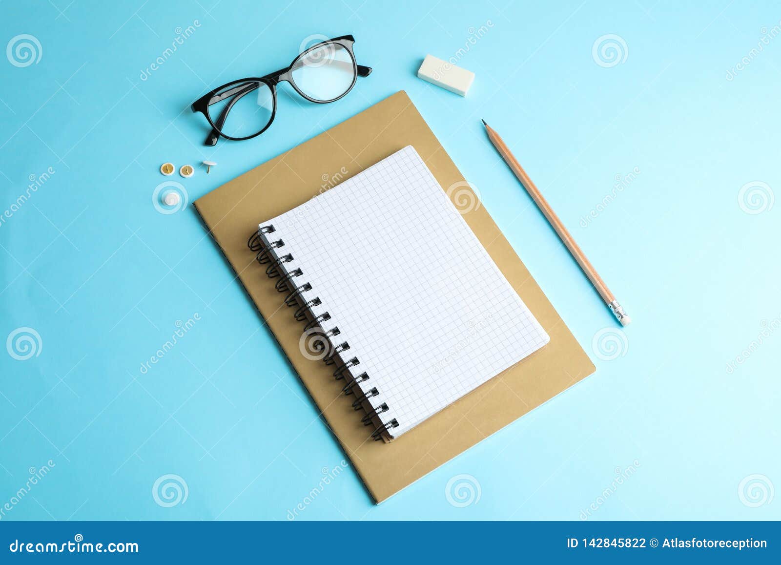 Copybooks, pencil and glasses on color background, space for text