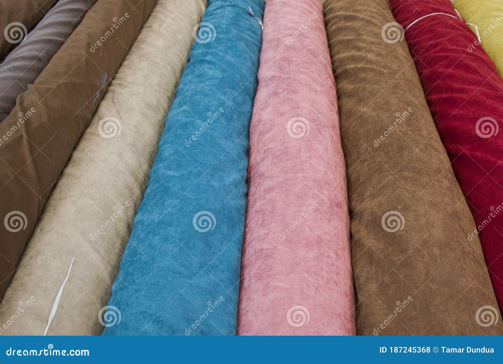 fabricate silk and cloth on the shop shelf, rolled silk in the market, multicolor and many pattern texture background