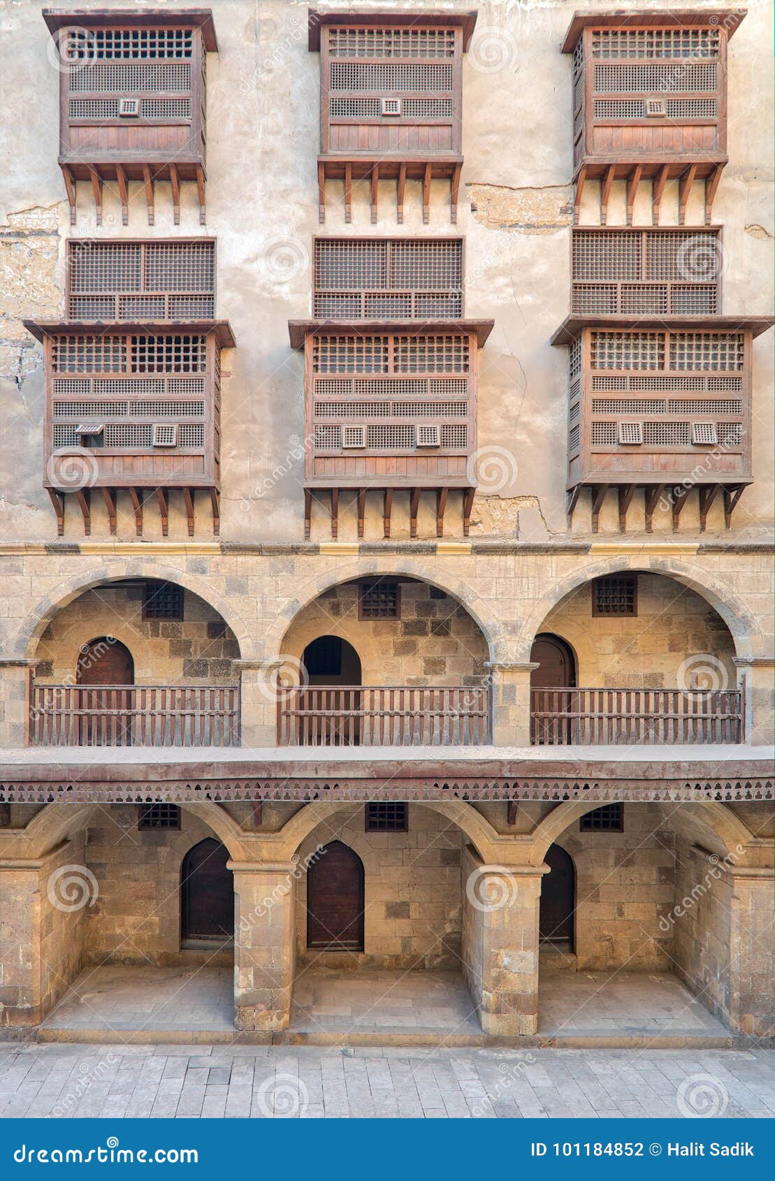 facade of caravansary of bazaraa, with vaulted arcades and windows covered by interleaved wooden grids mashrabiyya, cairo, egypt