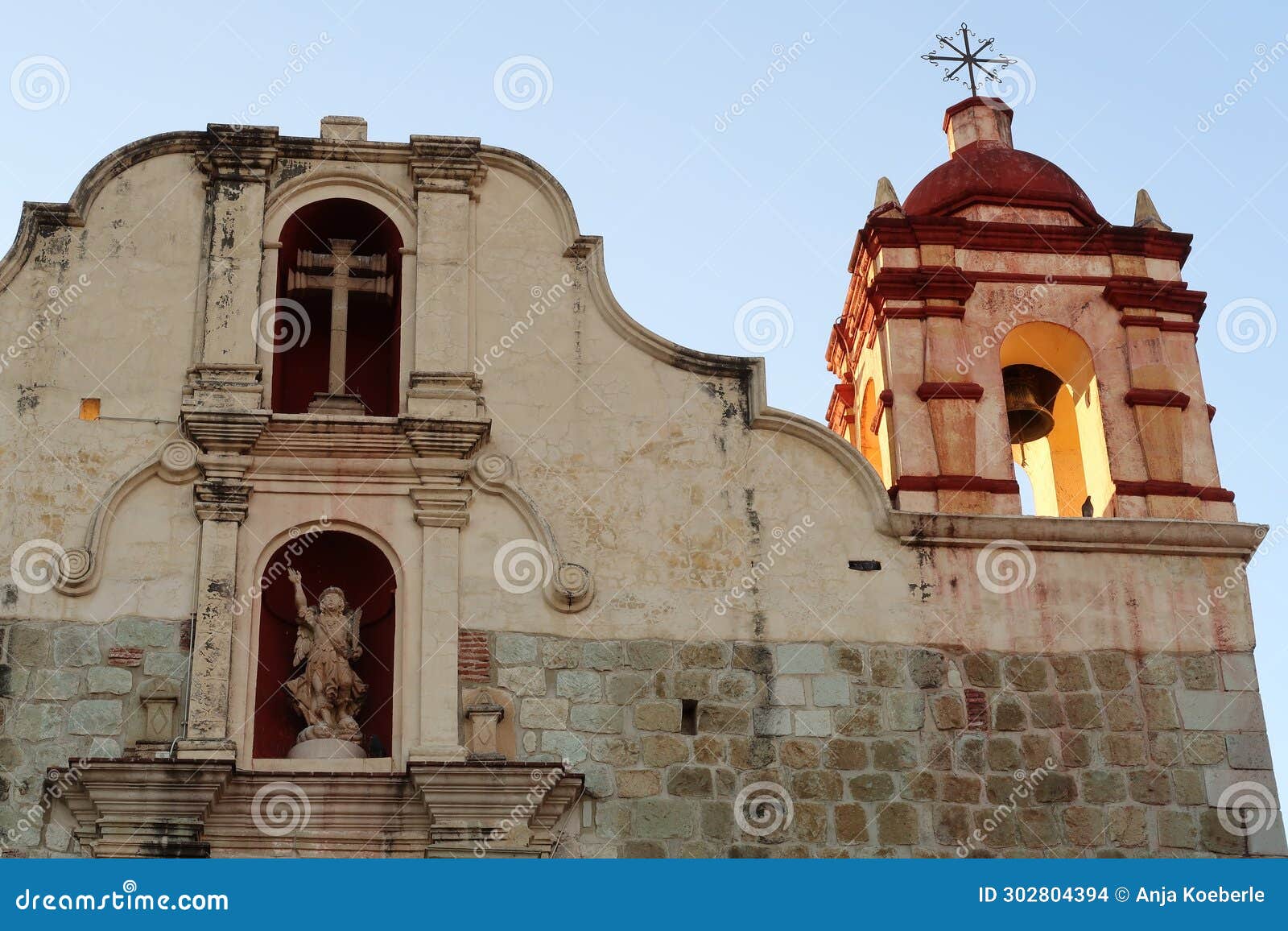 facade of the church iglesia preciosa sangre de cristo with its beautiful bell tower and ornaments, oaxaca, mexico