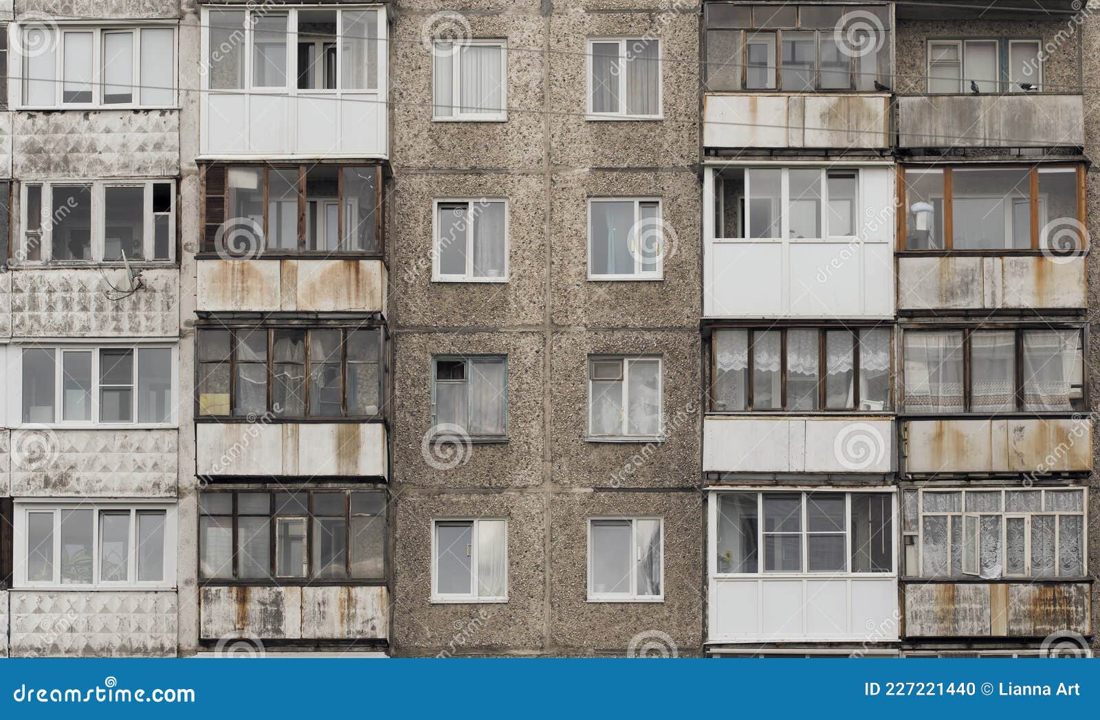 facade of a grey multi-storey soviet panel building