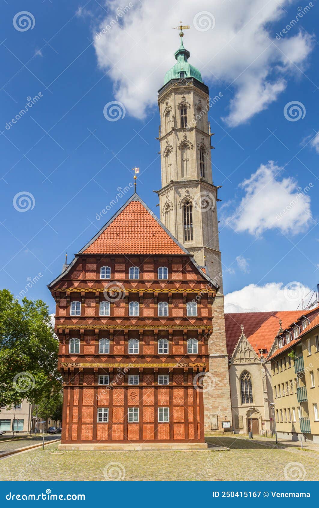 facade of the historic alte waage building and church tower in braunschweig