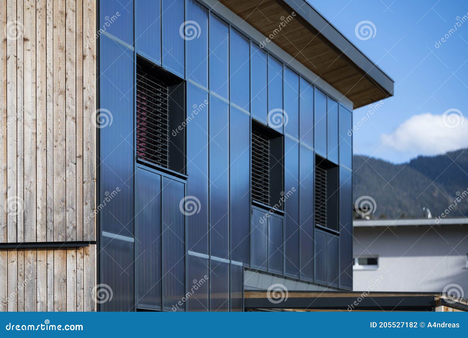 facade of a sustainable wooden prefabricated house with solar thermal collectors for heating