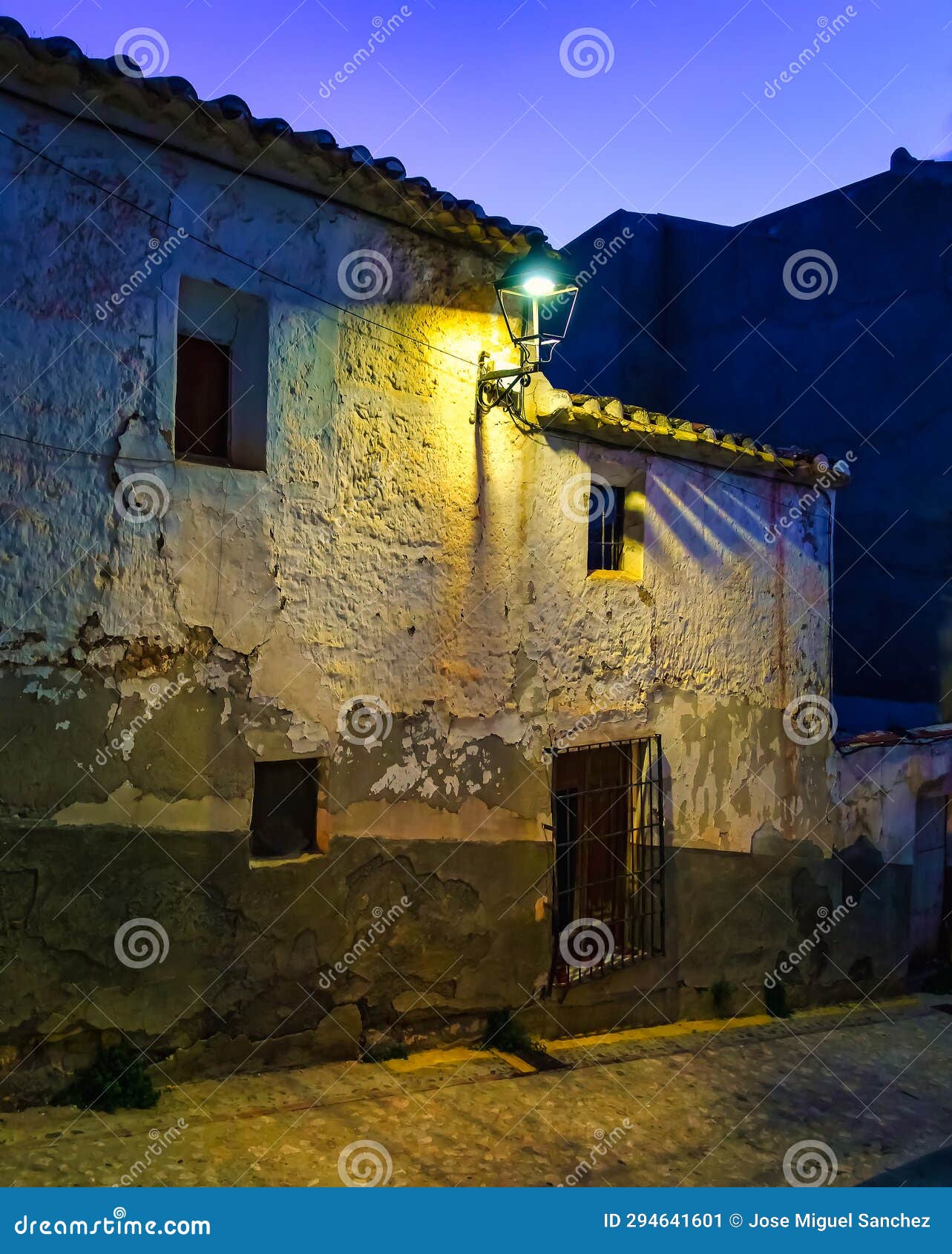 facades of whitewashed old houses at dusk in the picturesque village of velez rubio, almeria.