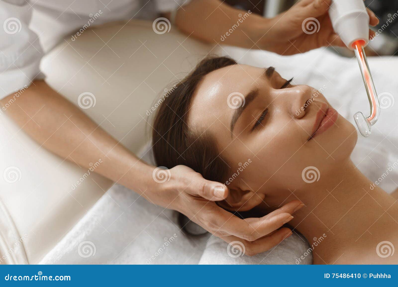 face beauty treatment. woman using darsonval skin care device