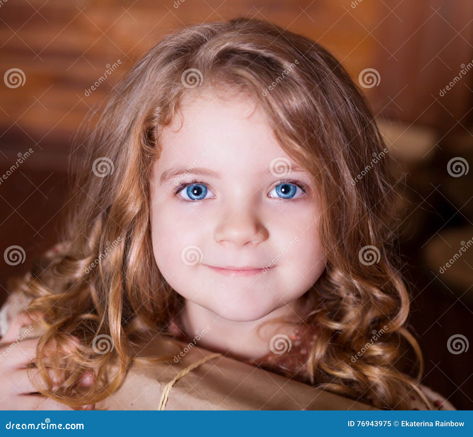 baby girl with green eyes and curly brown hair