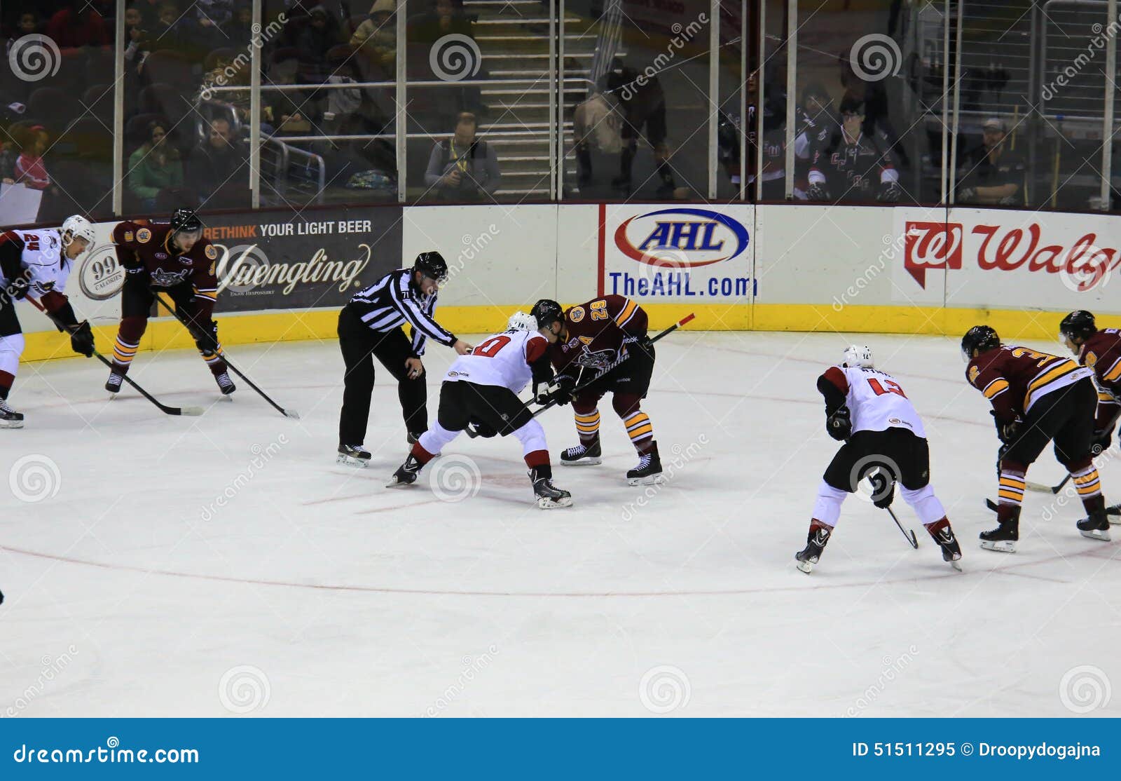 Faceoff Referee Putting A Puck Between Two Ice Hockey Players In Ice