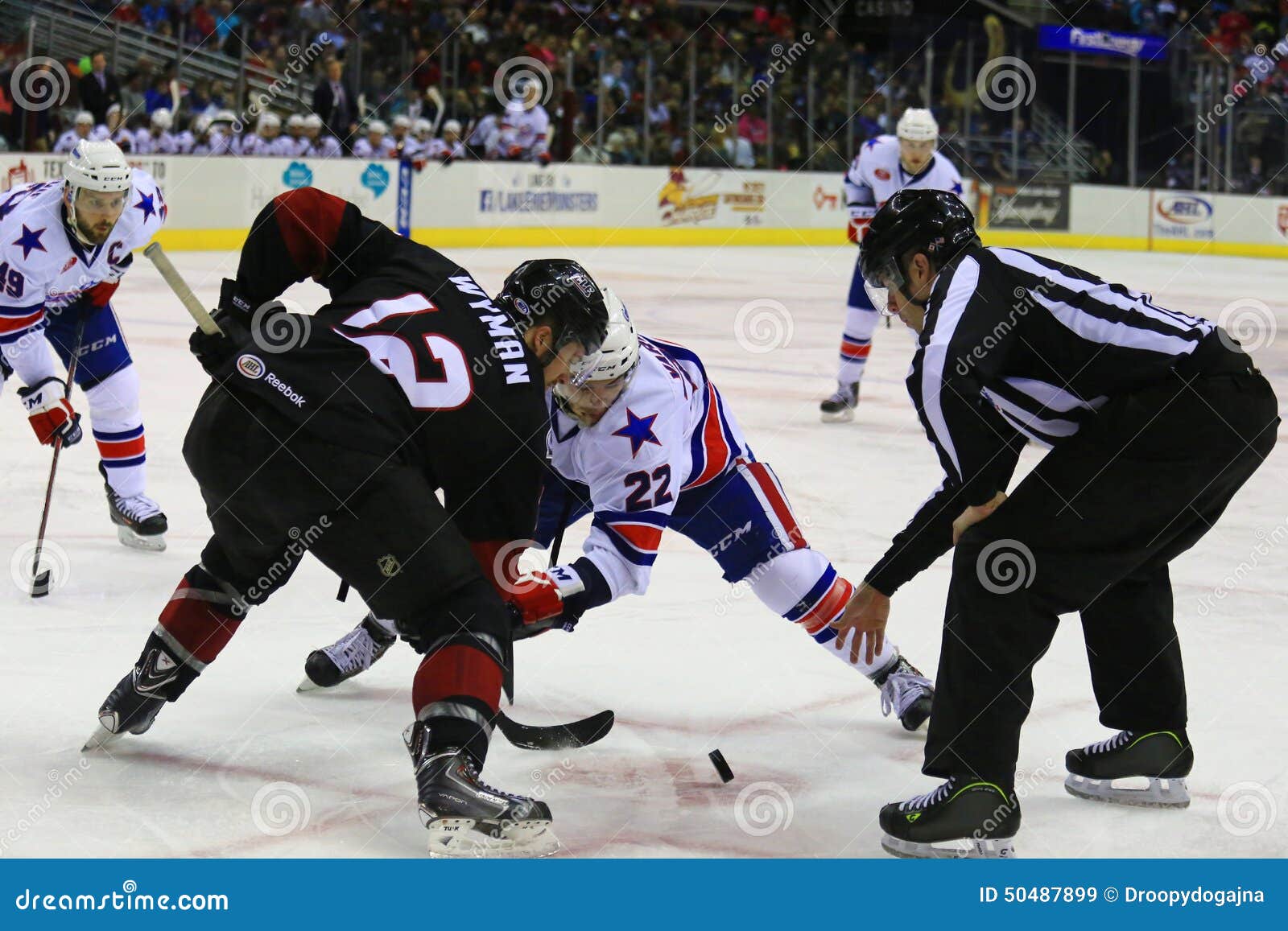 Faceoff Referee Putting A Puck Between Two Ice Hockey Players In Ice