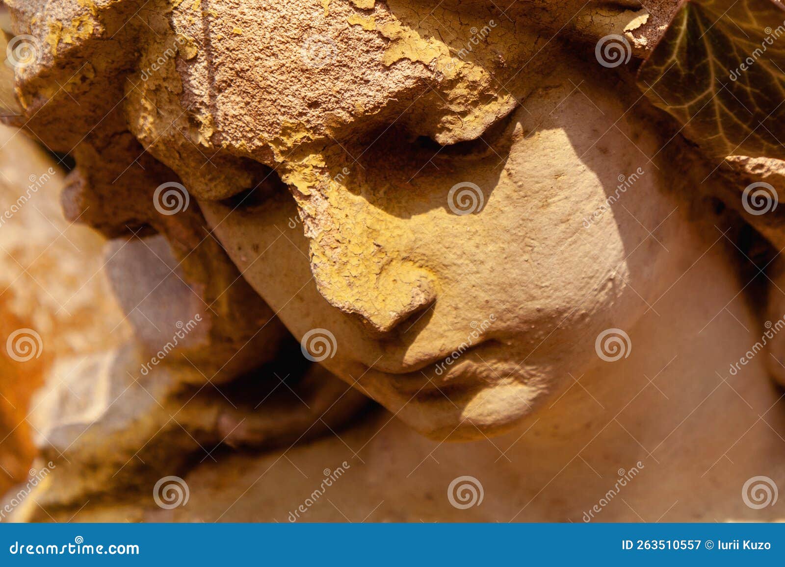 face of sad beautifuul angel as  of pain, fear and end of life. close up fragment of an ancient stone statue