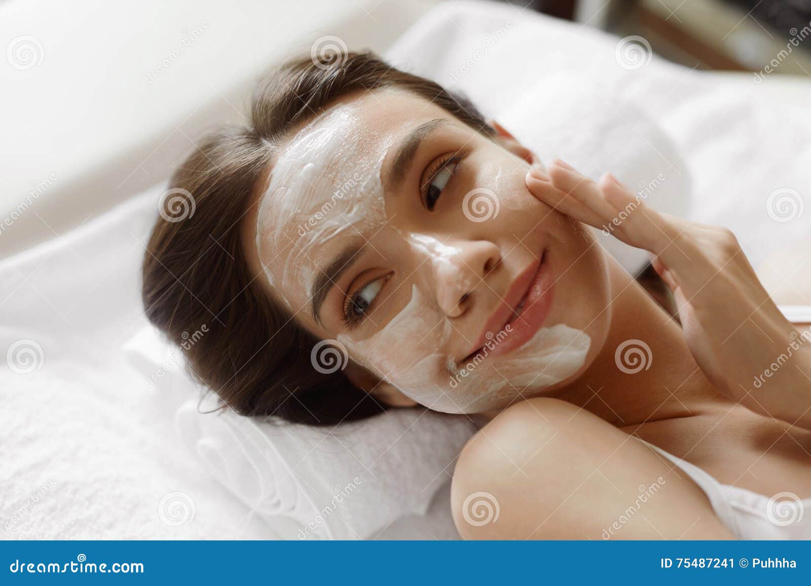 face skin care. beautiful woman with facial cosmetic mask at spa