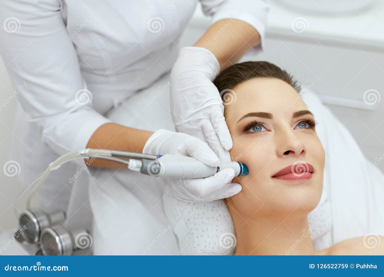 face skin care. closeup of woman face cleansing at cosmetology