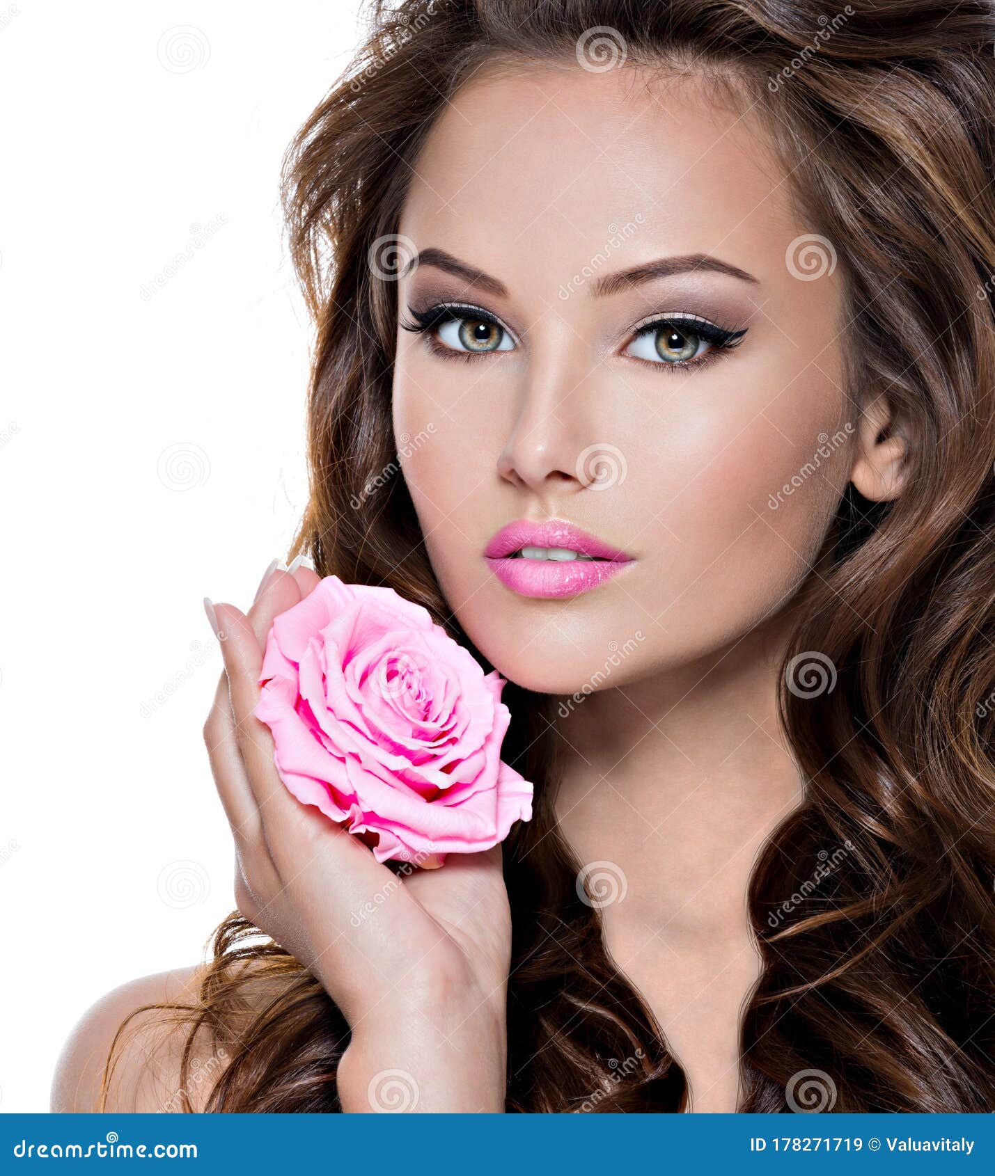 Face Of A Beautiful Woman With Long Brown Hairs And Pink Flower Stock