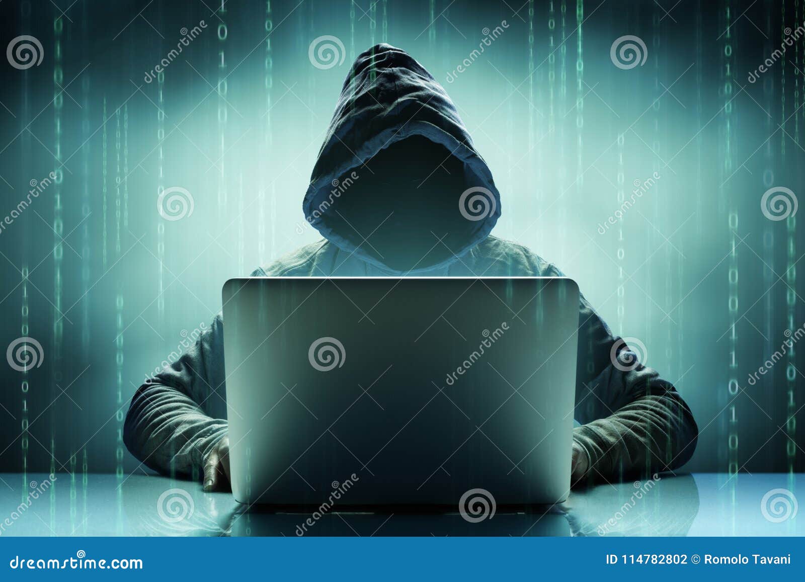 faceless anonymous computer hacker with laptop