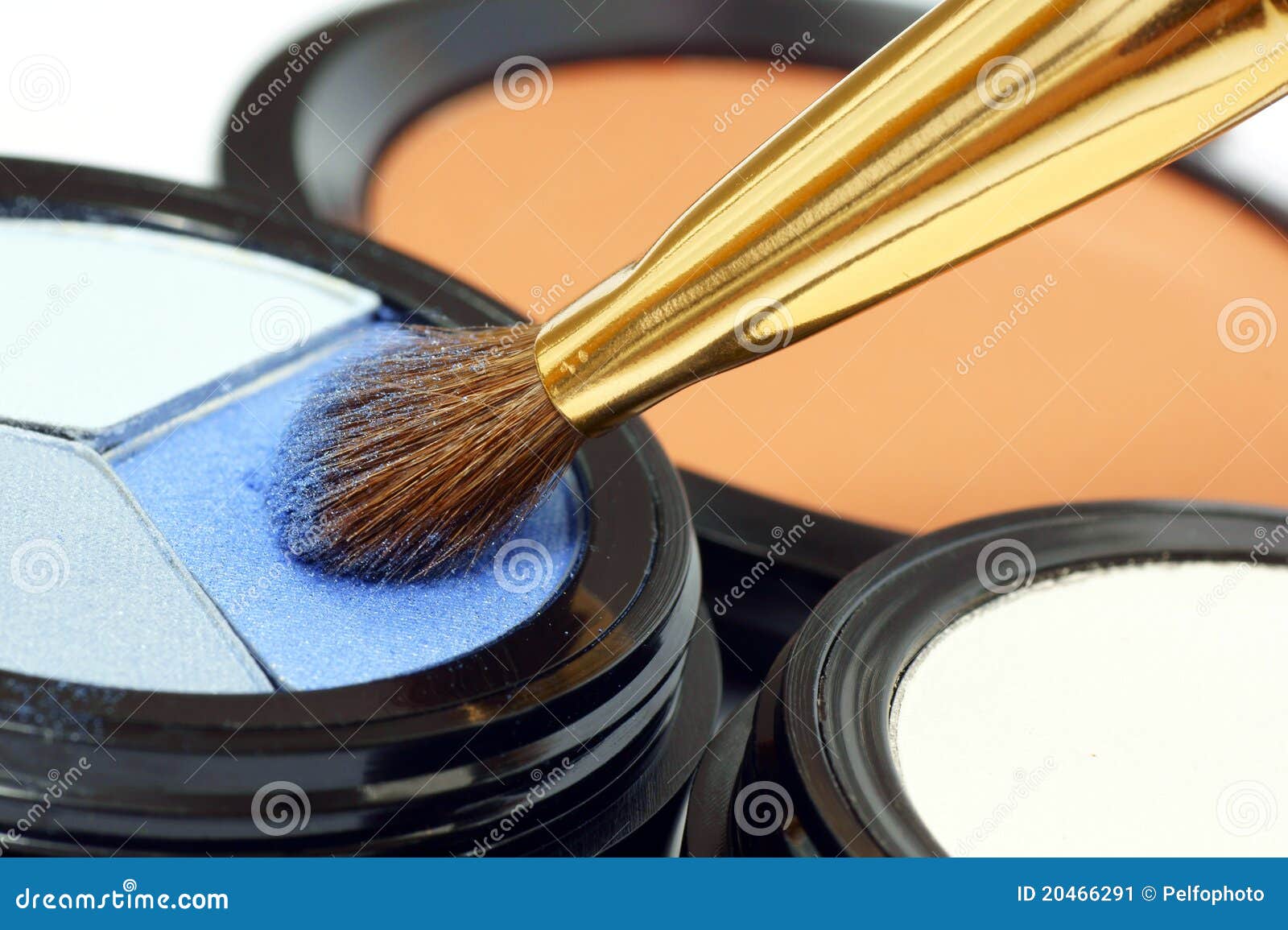 Facial makeup. Applying eye makeup on the brush.