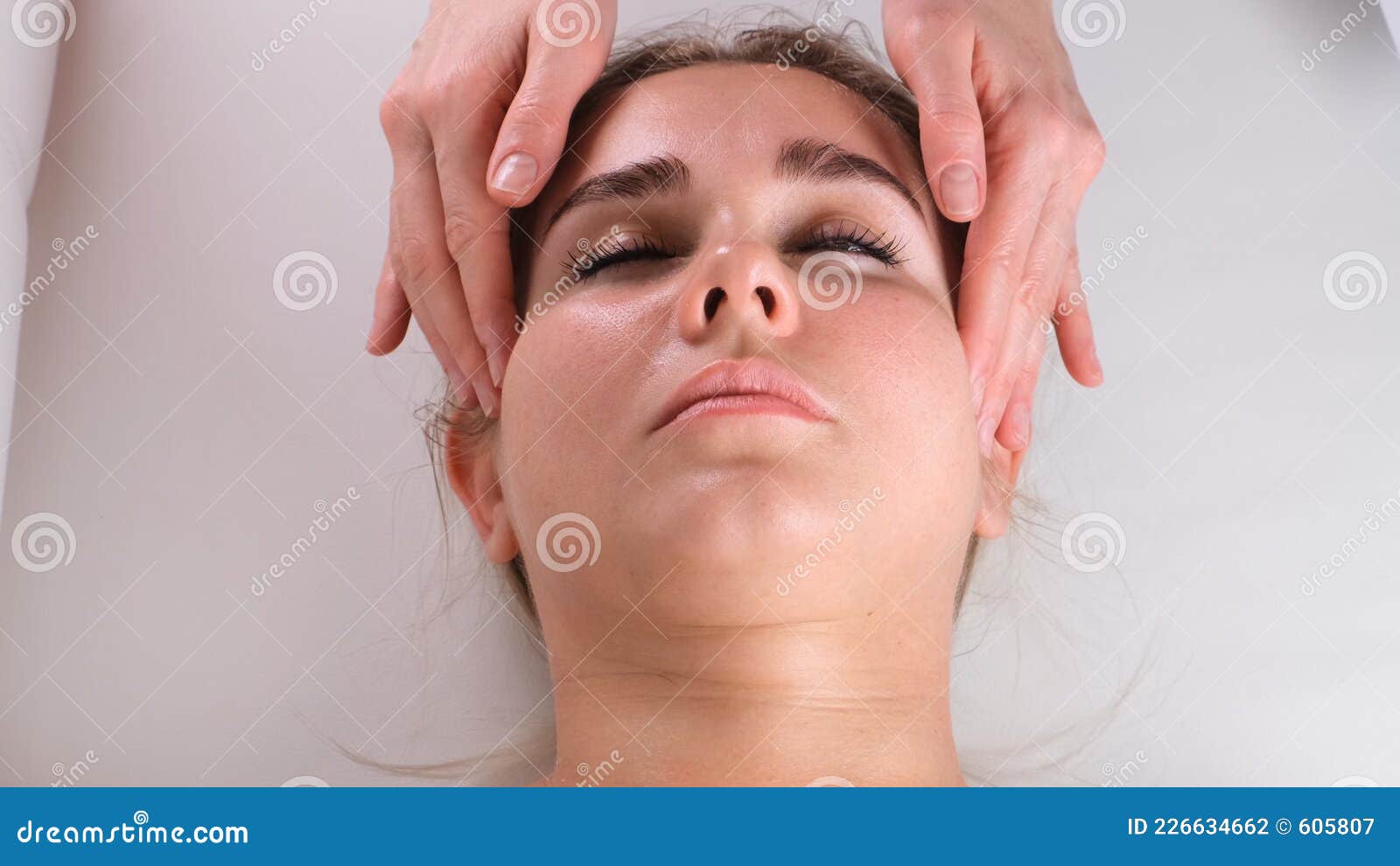 Facial Massage Beauty Treatment Close Up Of A Young Womans Face Lying On Back Getting Face