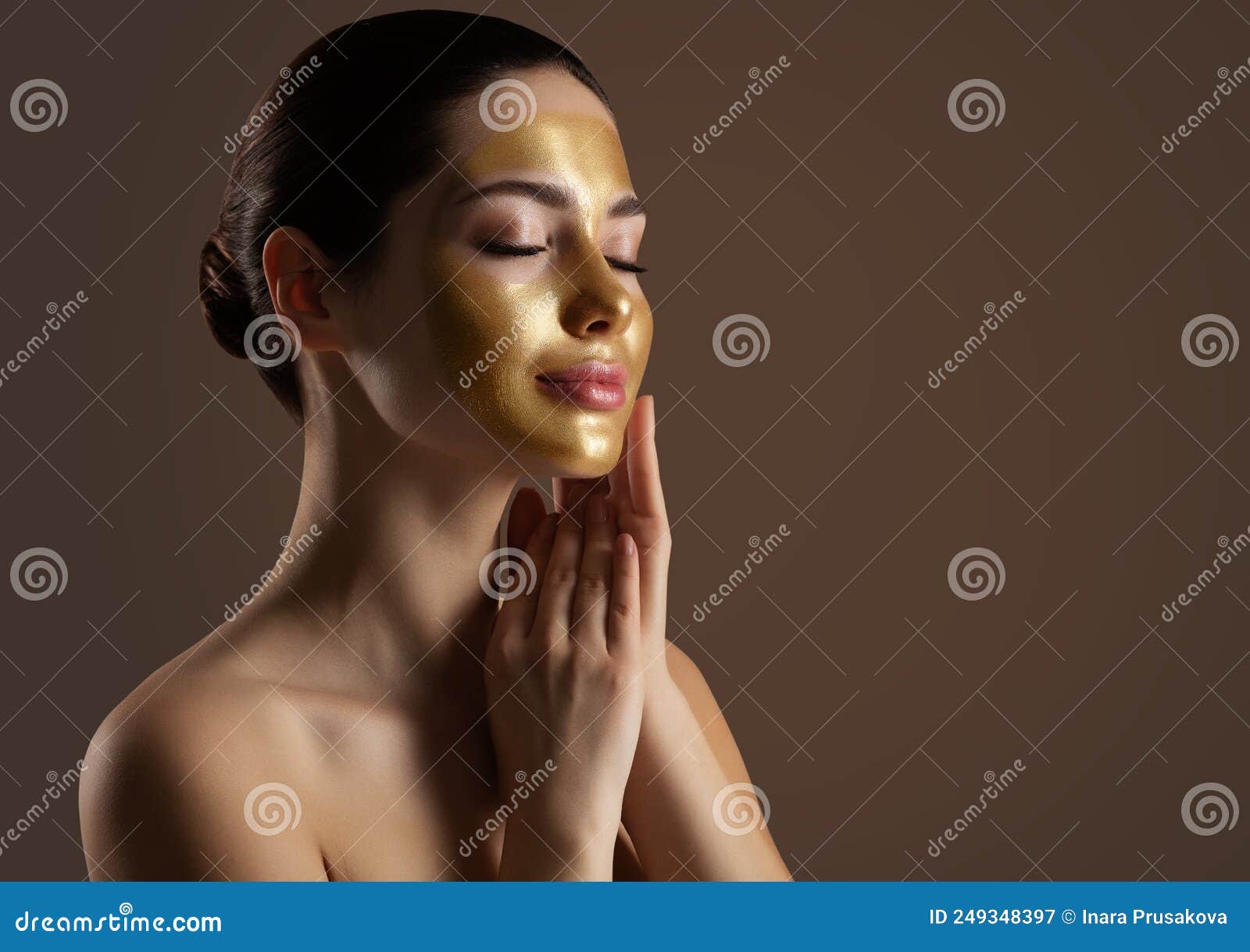 facial peeling golden mask. woman with gold lifting face mask over dark background. beauty model enjoying skin care spa