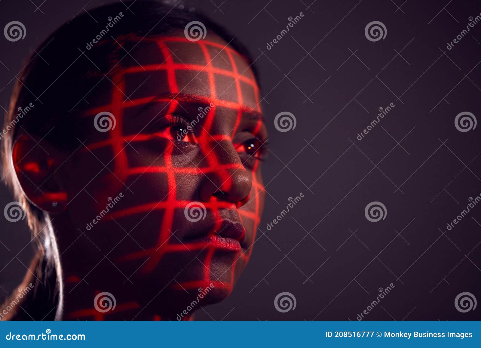 facial recognition technology concept as woman has red grid projected onto face in studio