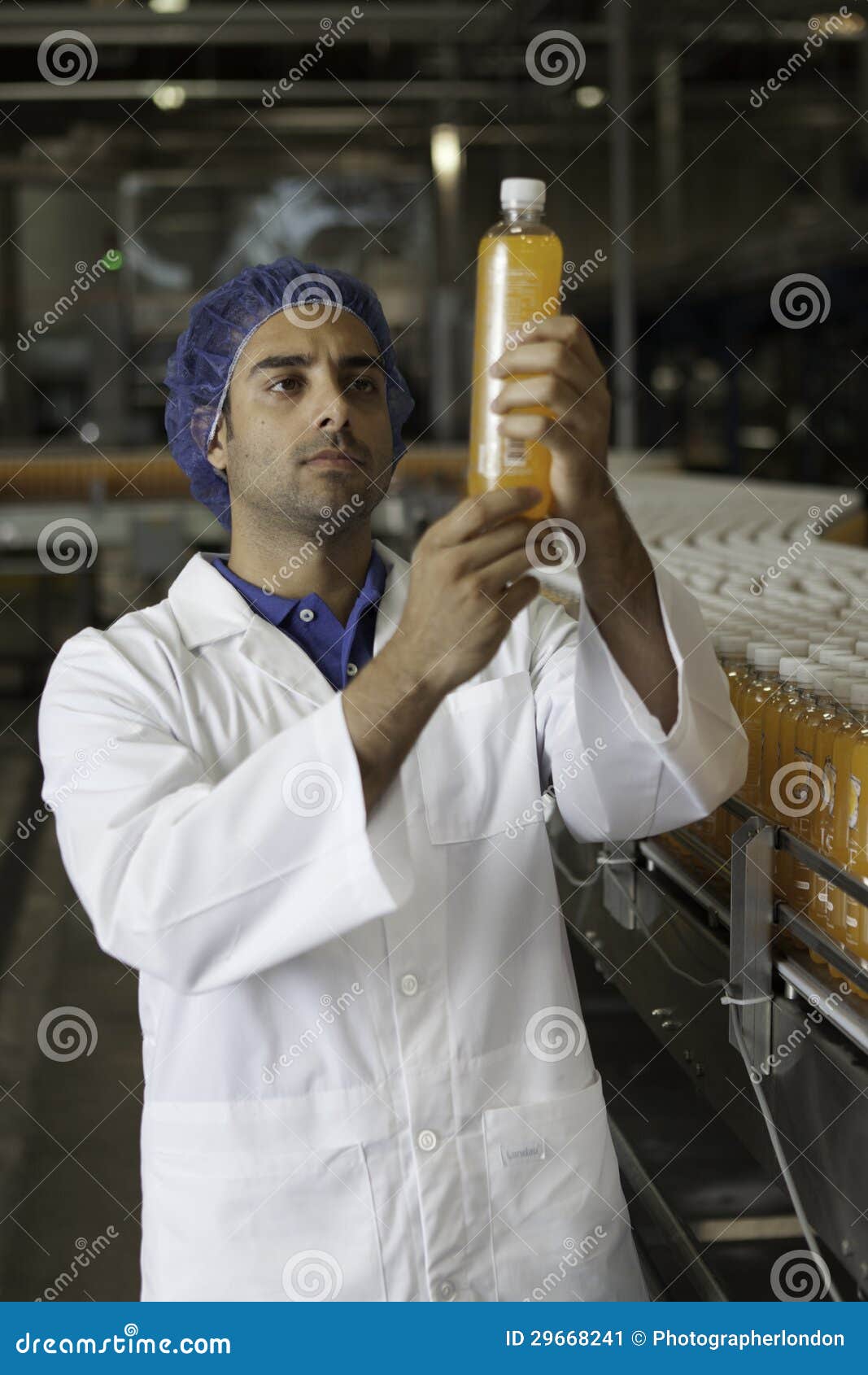 Factory Worker Examining Orange Juice Bottle Stock Image Image of