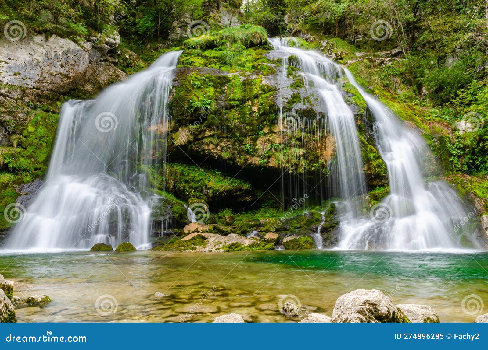 fairytale virje waterfall in slovenia - pluzna. dreamy and beautiful natural double waterfall shot on long exposure.