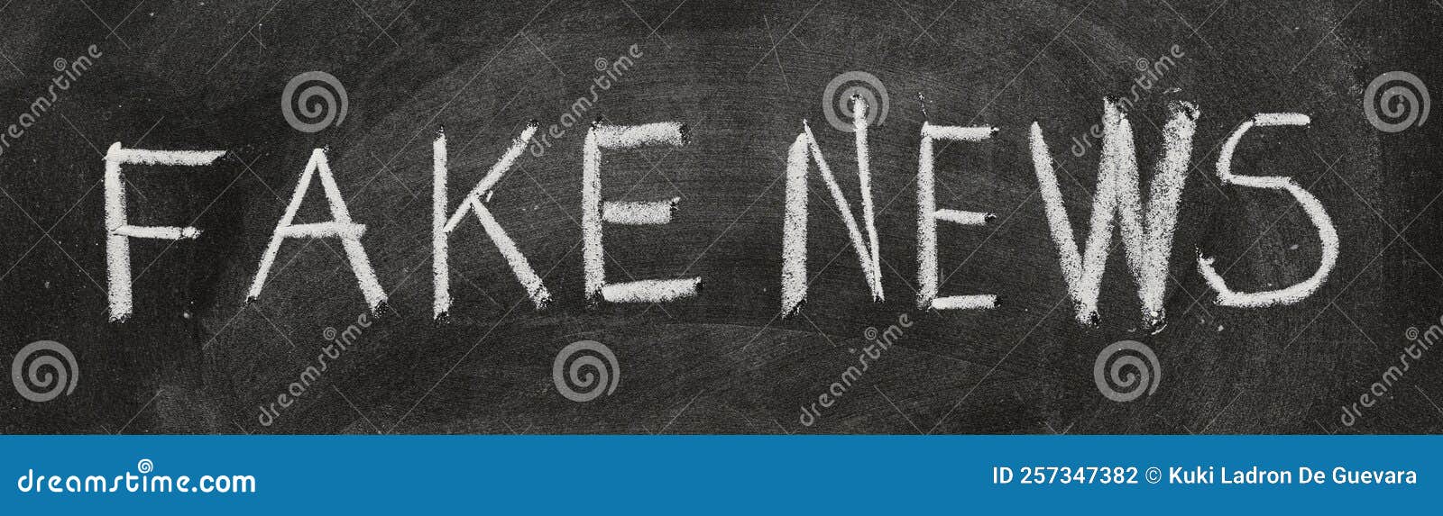 fake news written with chalk on blackboard