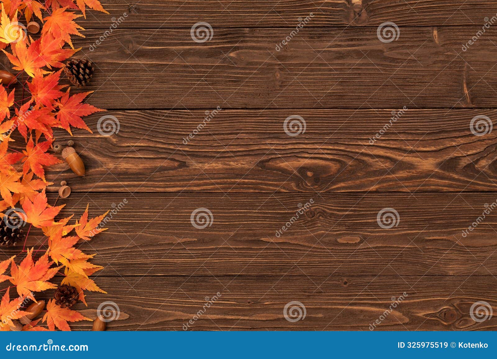 fall background with orange maple leaves border on brown wooden table