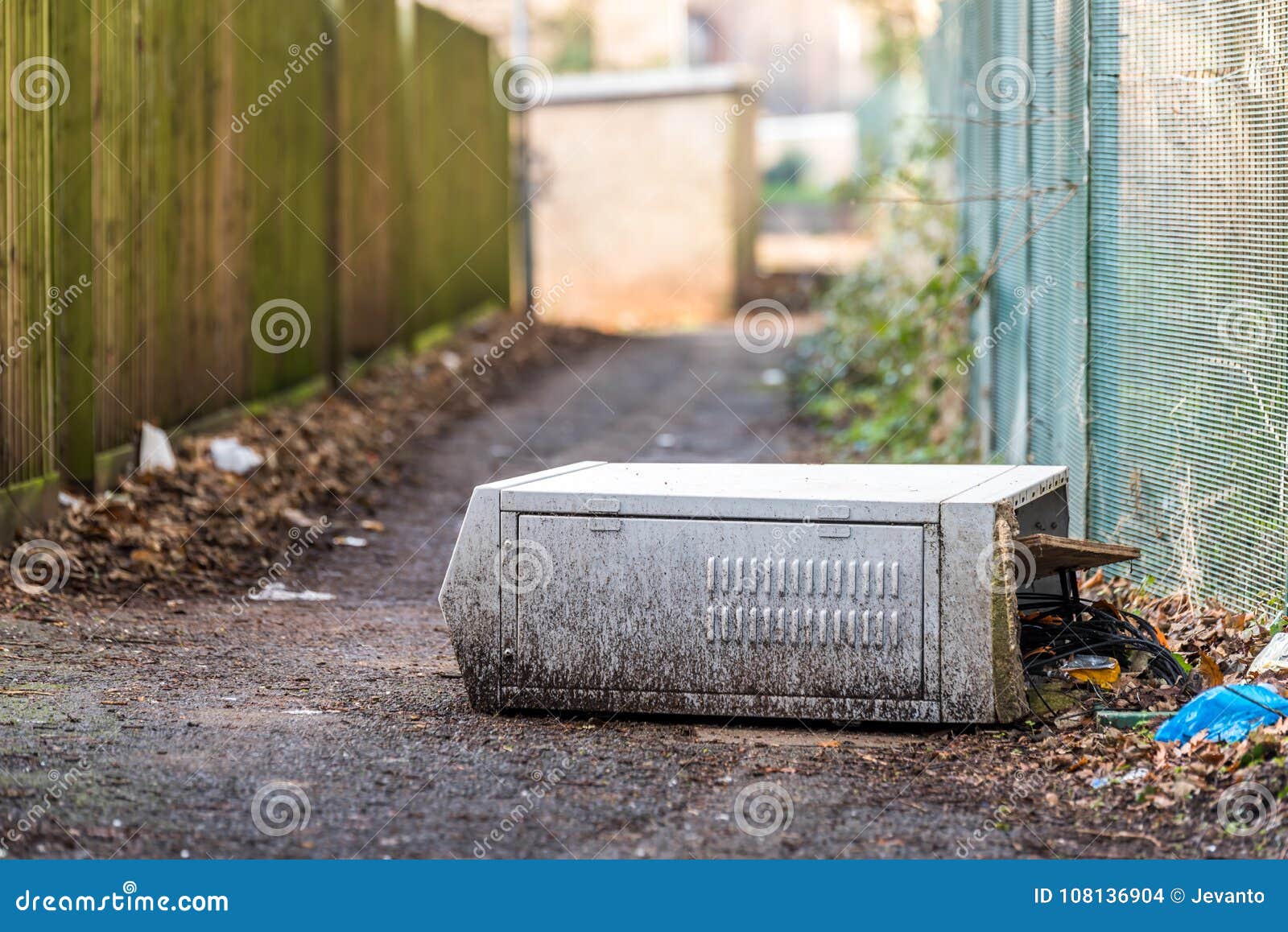 Fallen Broken Electrical Box Outdoors on Footpath with Cable Wires