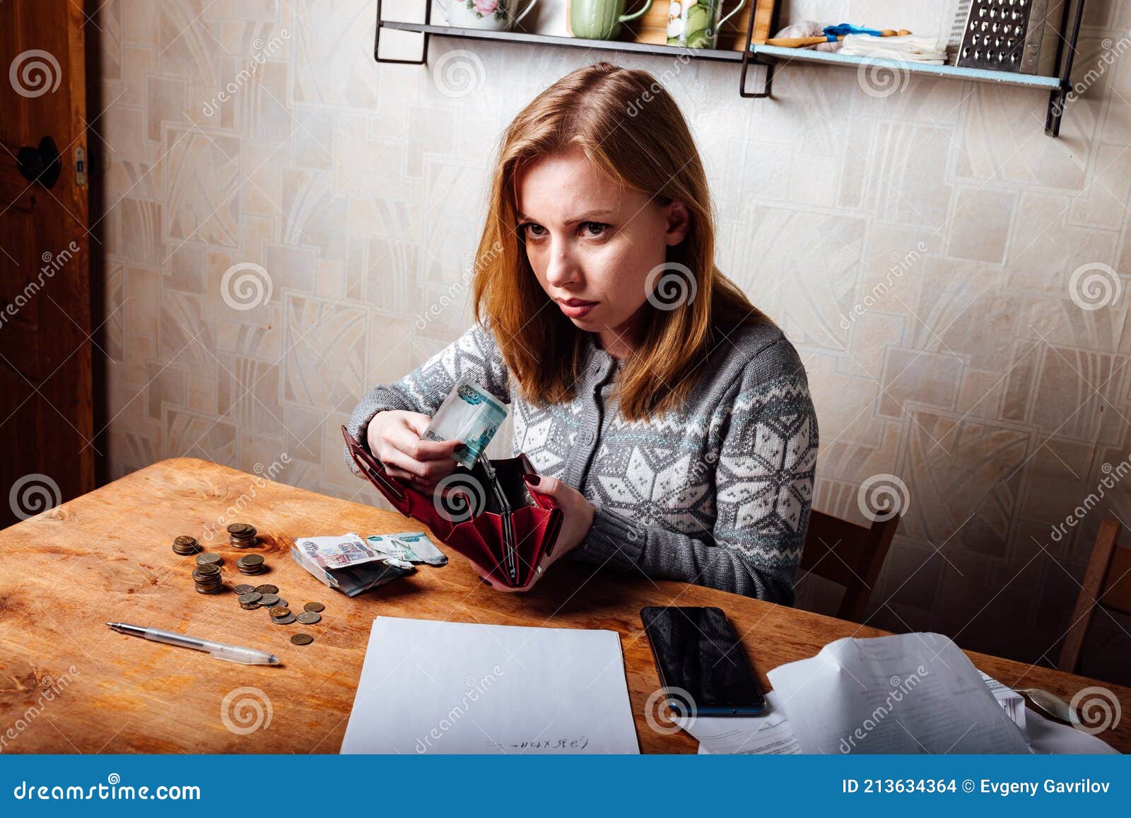 The Girl Calculates Taxes And Fills Out The Documents On The Bills the-girl-calculates-taxes-and-fills-out-the-documents-on-the-bills