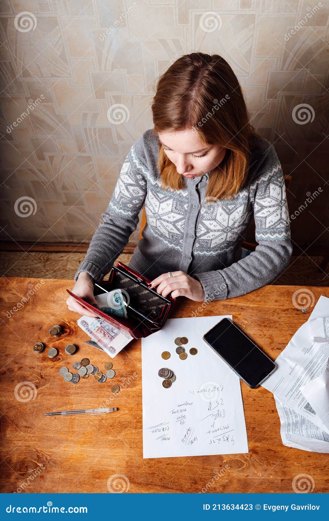 The Girl Calculates Taxes And Fills Out The Documents On The Bills the-girl-calculates-taxes-and-fills-out-the-documents-on-the-bills