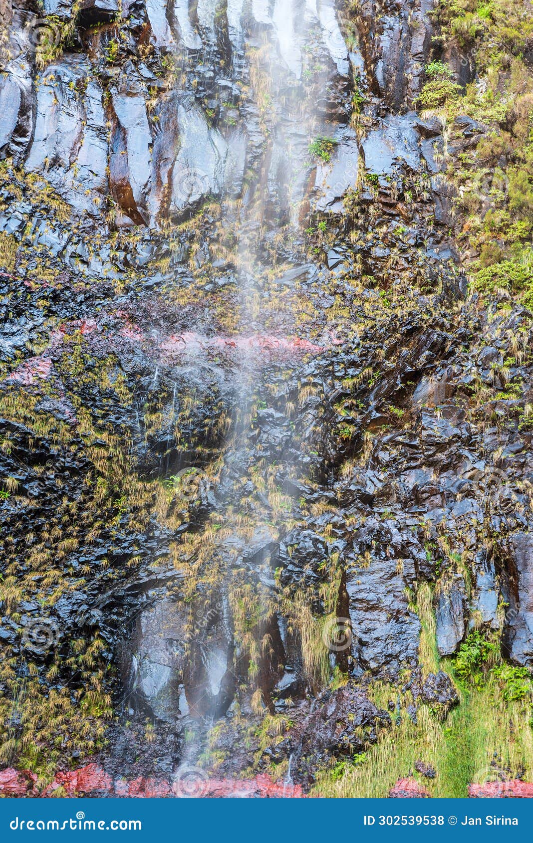 falling waterfall above lagoa do vento lake in madeira