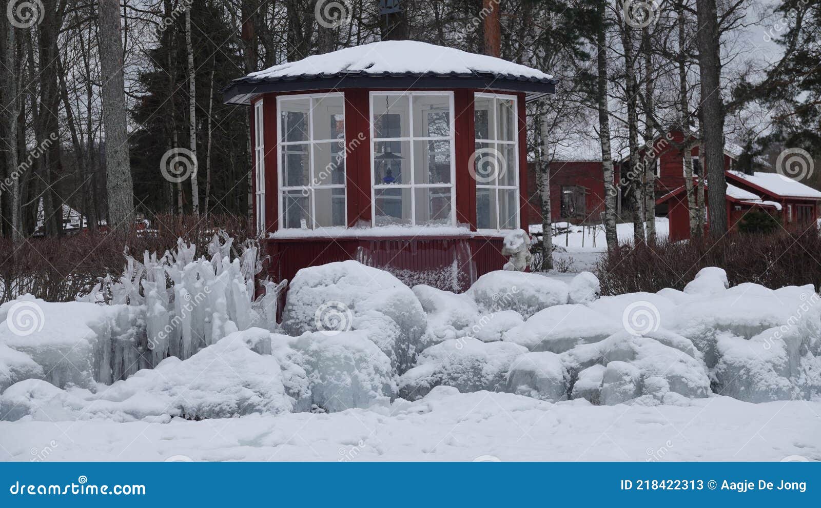 frozen rocks and teahouse on shore of lake siljan in tallberg near rattvik in dalarna in sweden