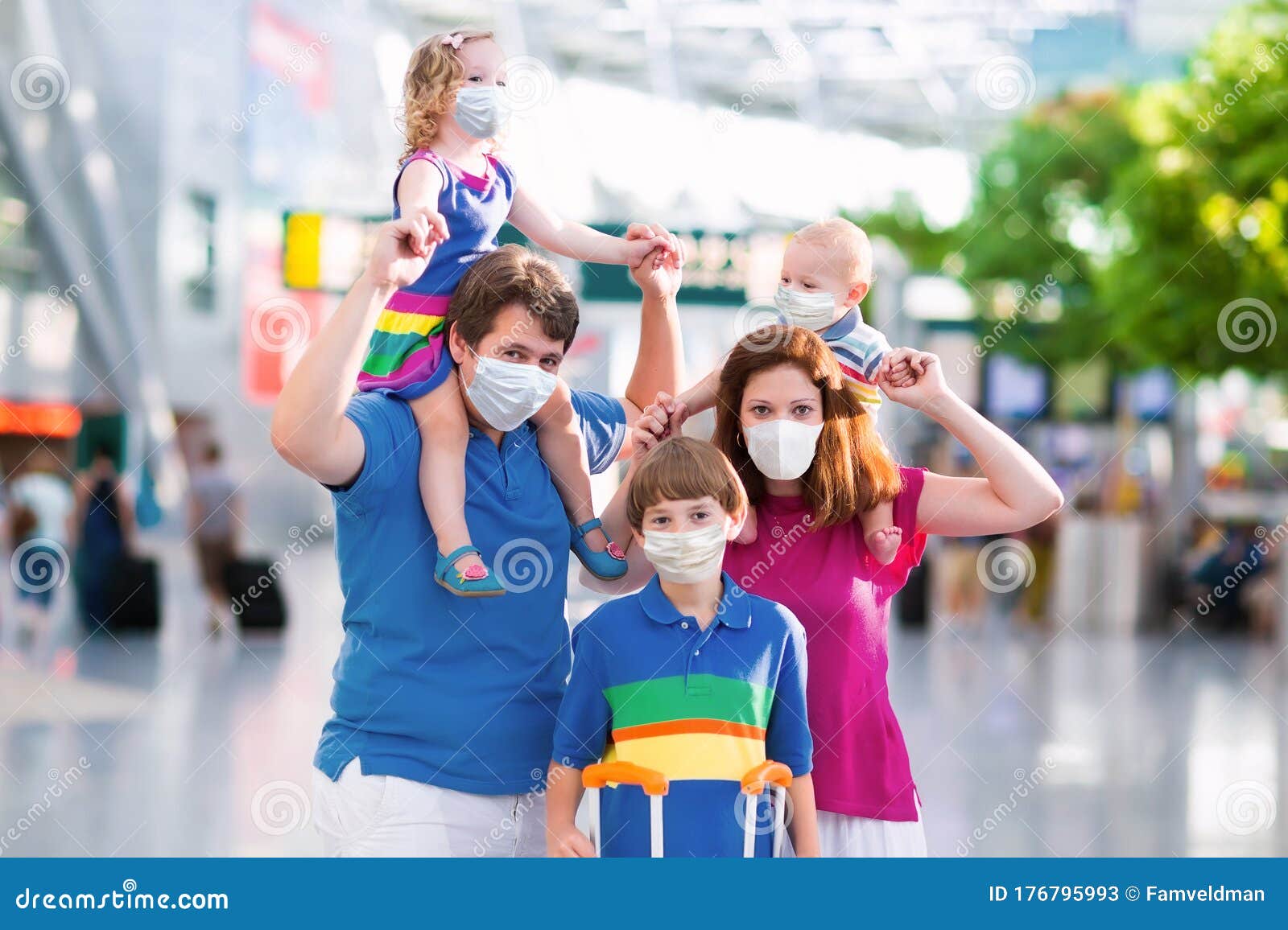 family in airport in face mask. virus outbreak