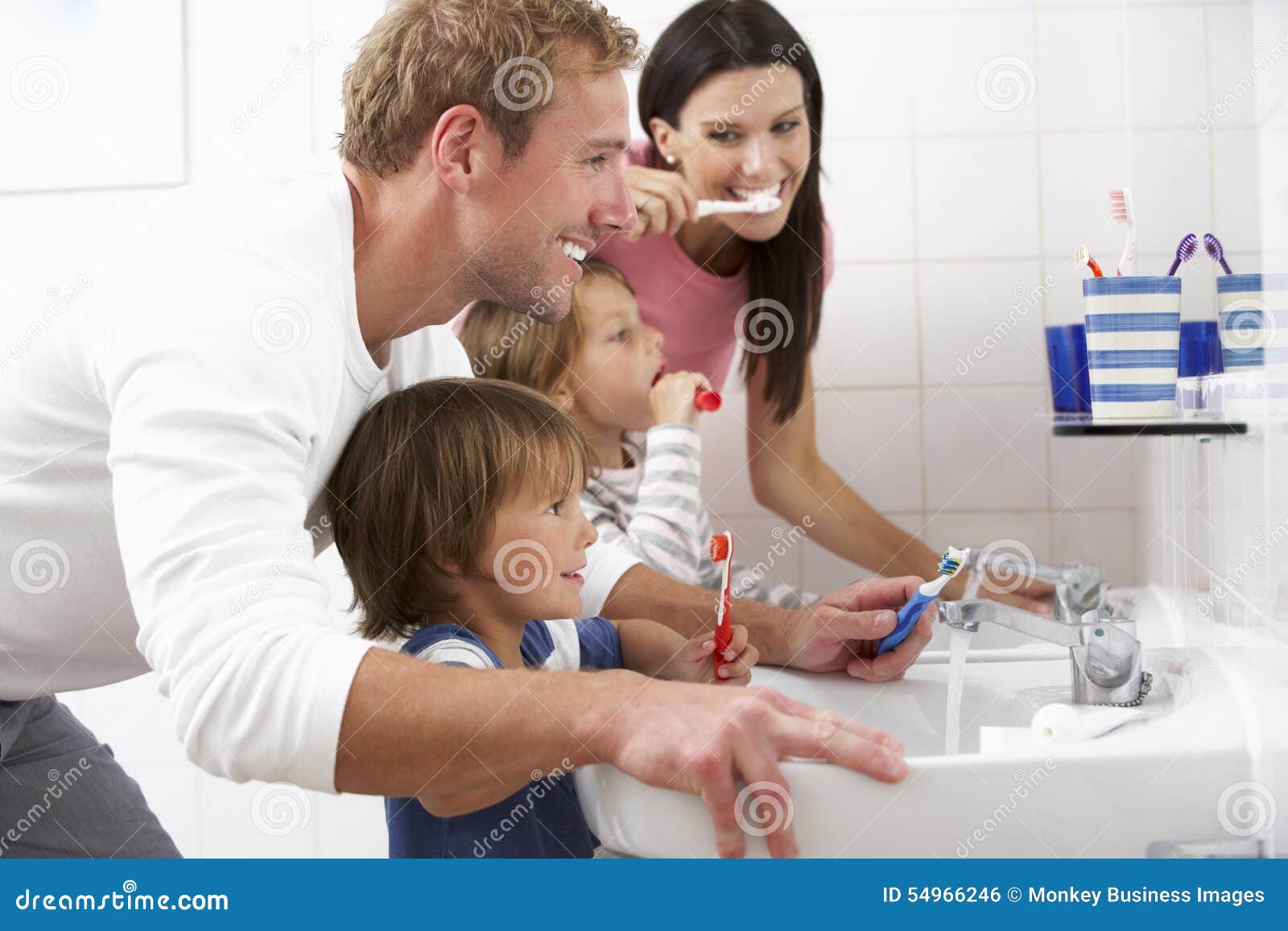 family in bathroom brushing teeth