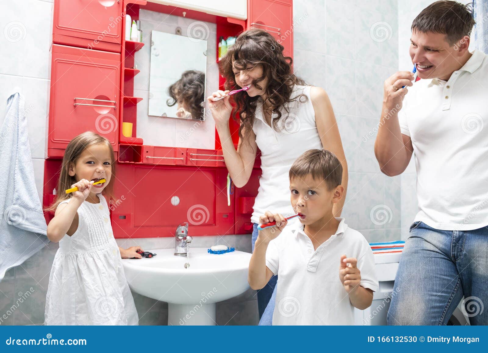 family . young caucasian family with the kids having fun in bathroom while brushing teeth together