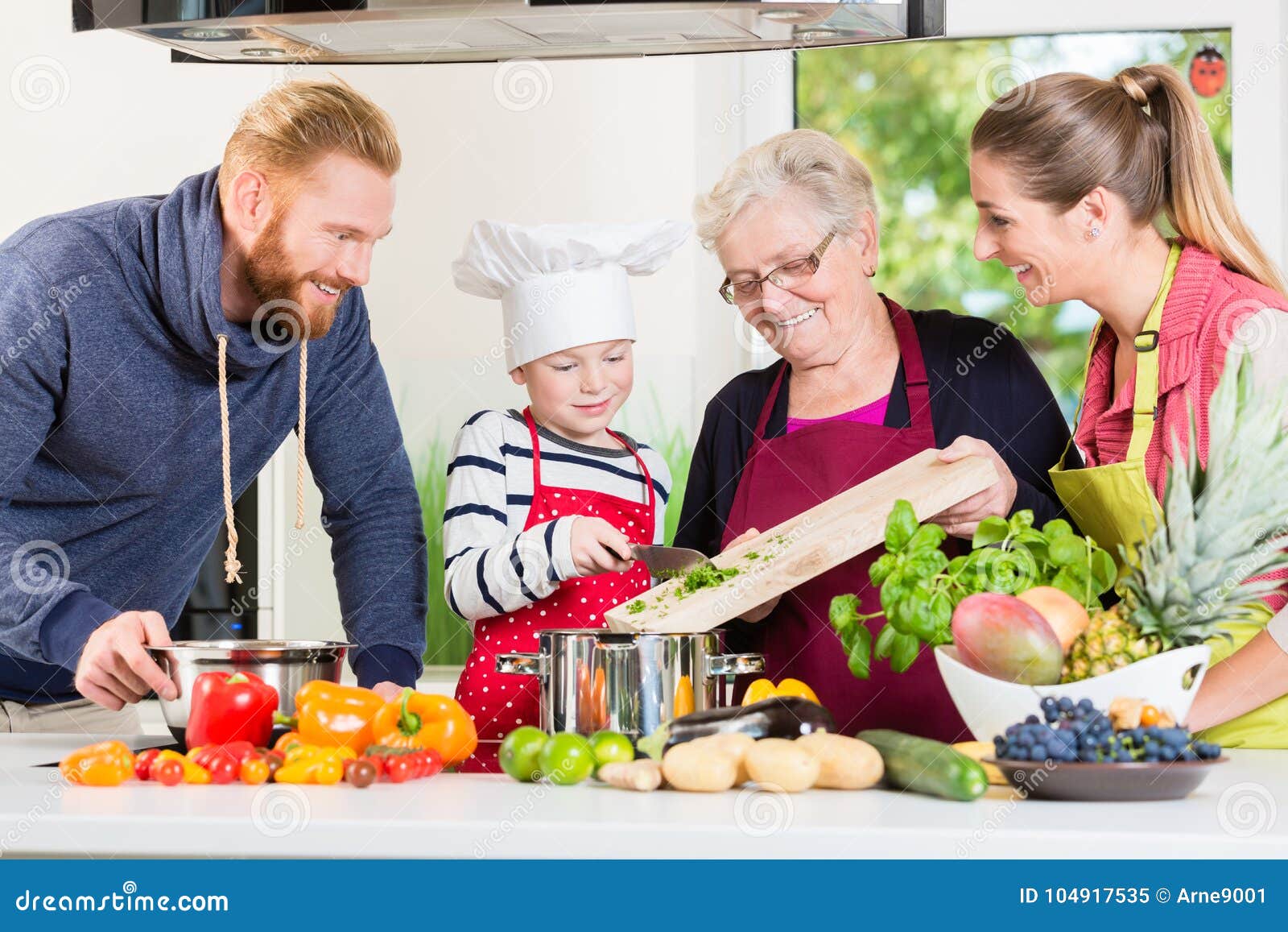 family cooking in multigenerational household with son, mother,