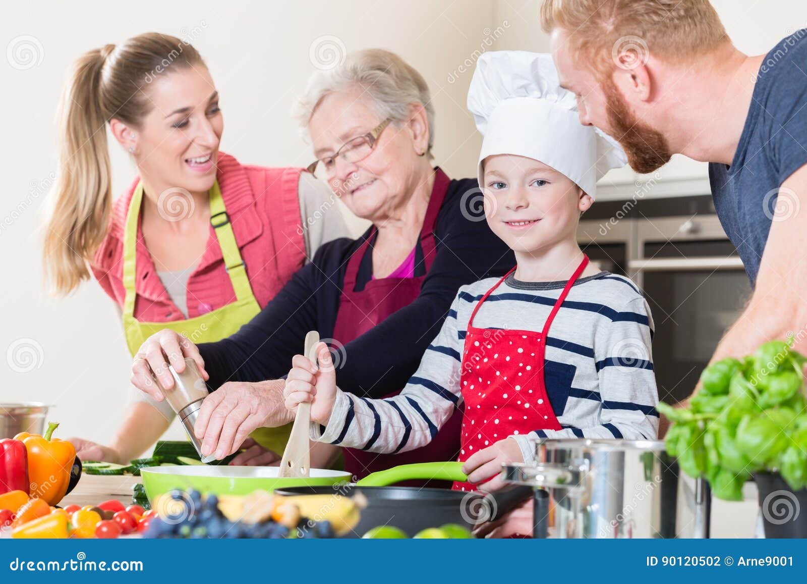 family cooking in multigenerational household with son, mother,