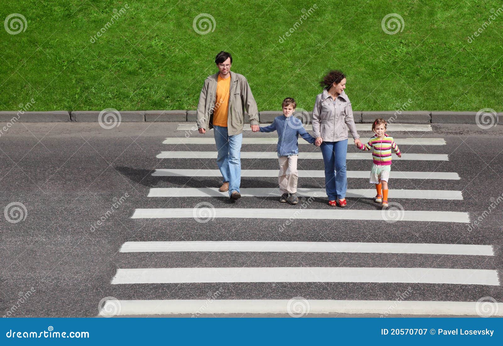 family and crossing road, green fence and grass