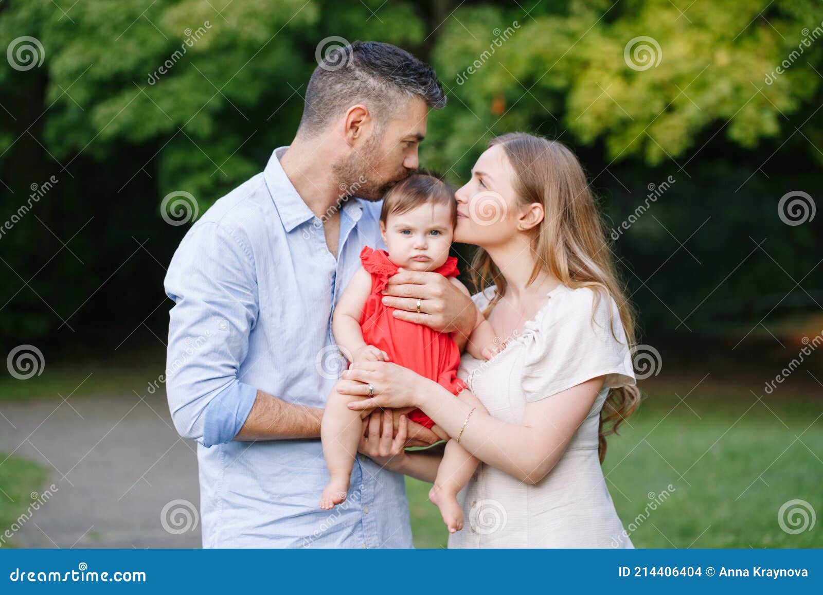 Family Day. Caucasian Mother and Father Kissing Baby Daughter in ...