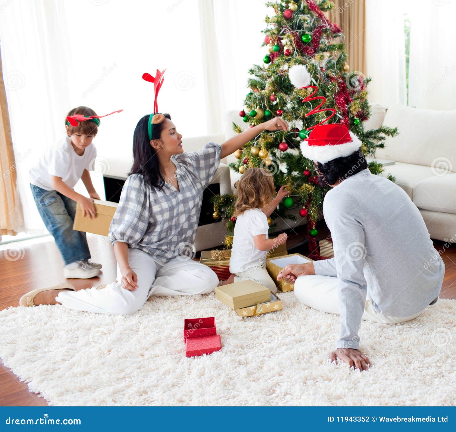 Family Decorating a Christmas Tree Stock Photo Image of cheerful
