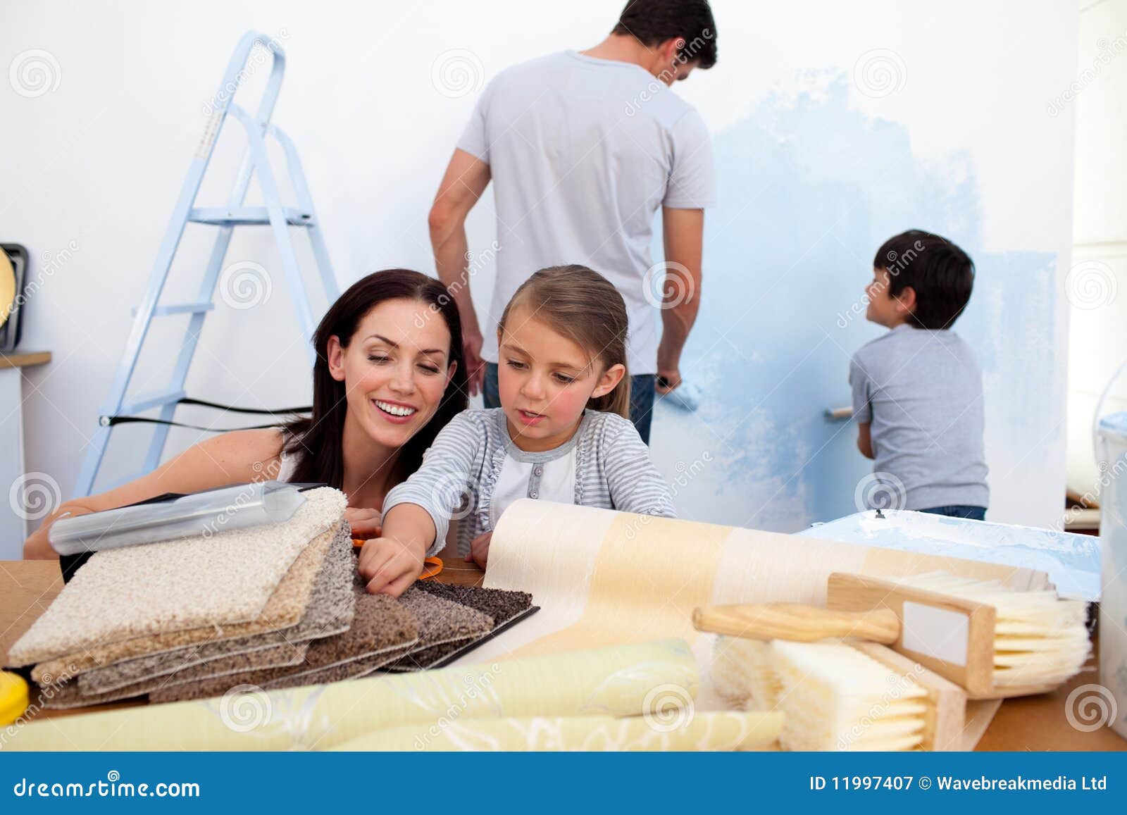 Family decorating a room stock image. Image of house - 11997407