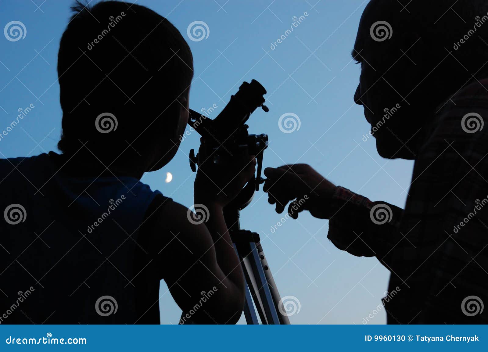 family discovering the moon with a telescope