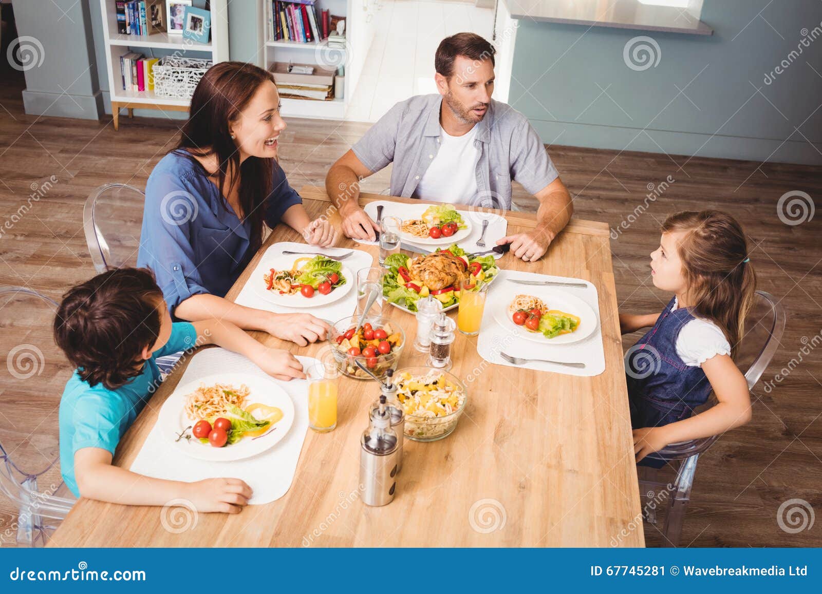 Family Discussing with Food on Dining Table Stock Image Image of
